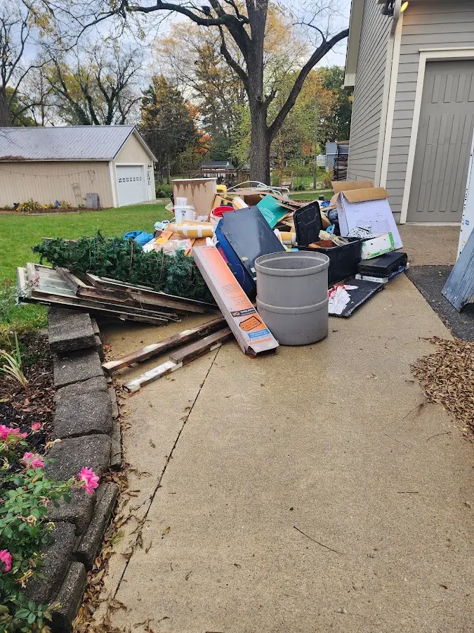 Dumpster being loaded with debris for Roofing Dumpster Rental in Butler